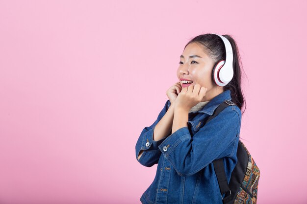 Female tourists in the studio on a pink background.