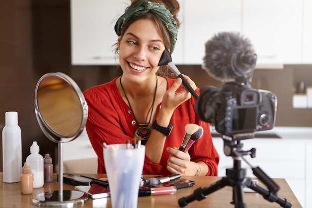 Female vlogger filming makeup video