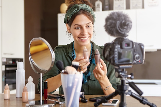 Female vlogger filming makeup video