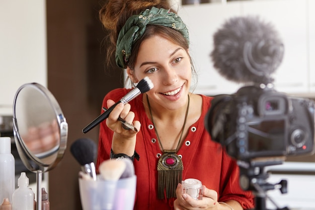 Free photo female vlogger filming makeup video