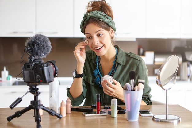 Female vlogger filming makeup video