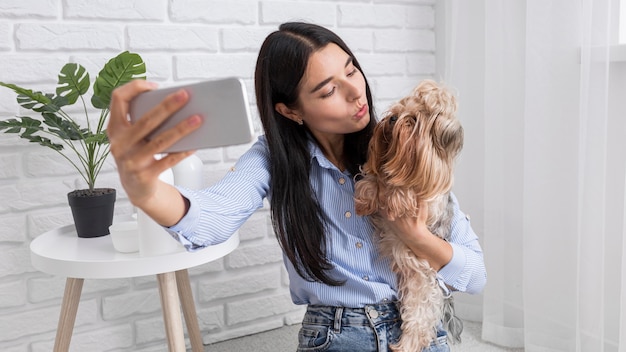 Female vlogger at home with smartphone