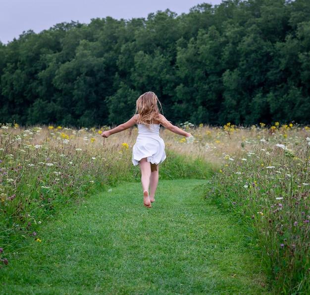 Free Photo female wearing a dress and running through a field