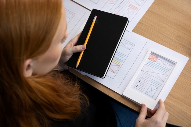 Female web designer in the office with notebook