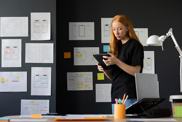 Female web designer in the office with notebook