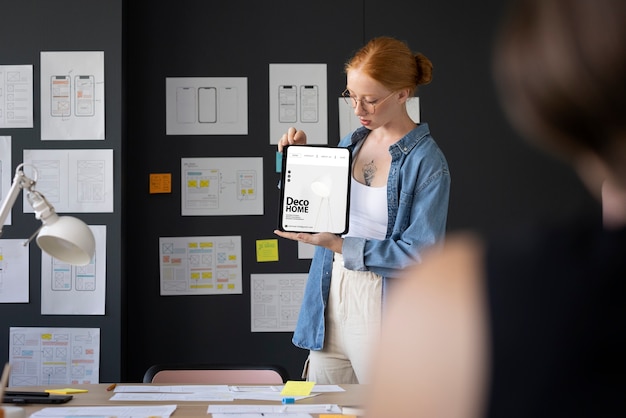 Free Photo female web designer in the office with tablet device