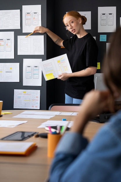 Female web designer with papers and notes in the office