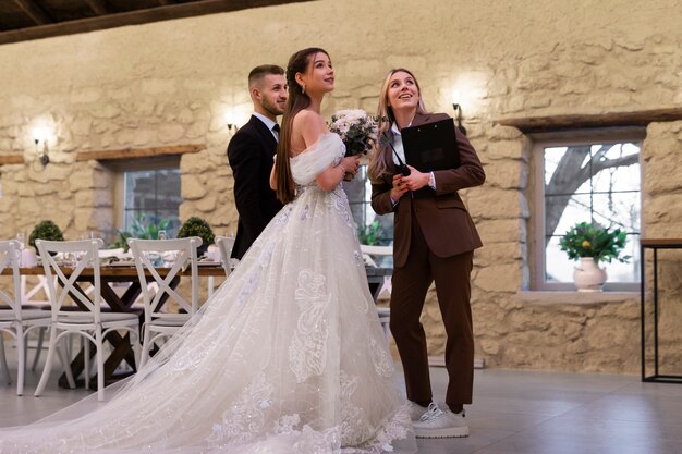 Female wedding planner working with bride and groom