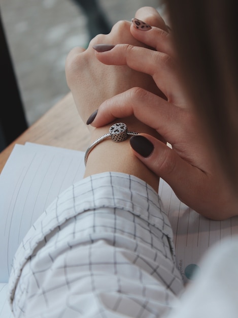 Free Photo female with a fashionable silver bracelet with a pendant