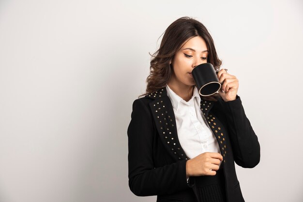 Female worker drinking tea seriously