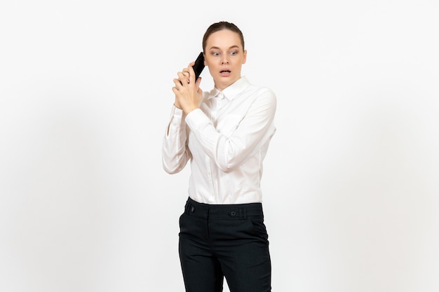 Free photo female worker in elegant white blouse talking on phone scared on white