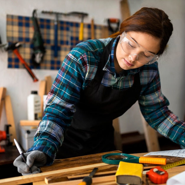 Free photo female working in workshop with measure tape