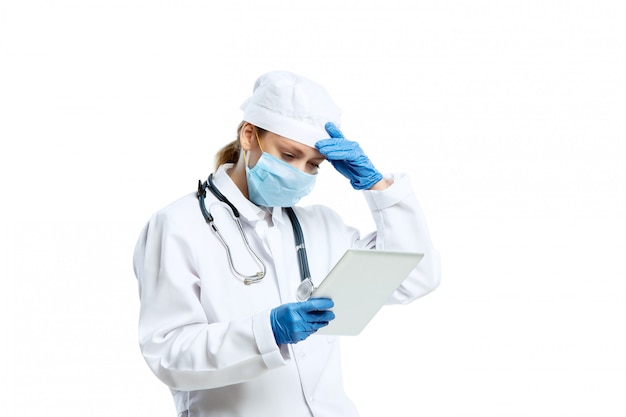 Female young doctor with stethoscope and face mask isolated on white