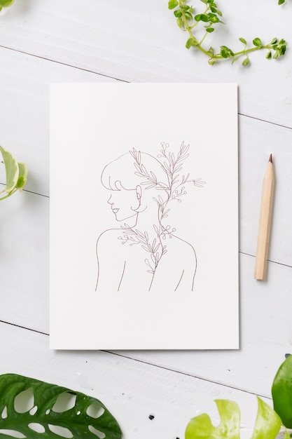 Free photo feminine line art drawing on white paper