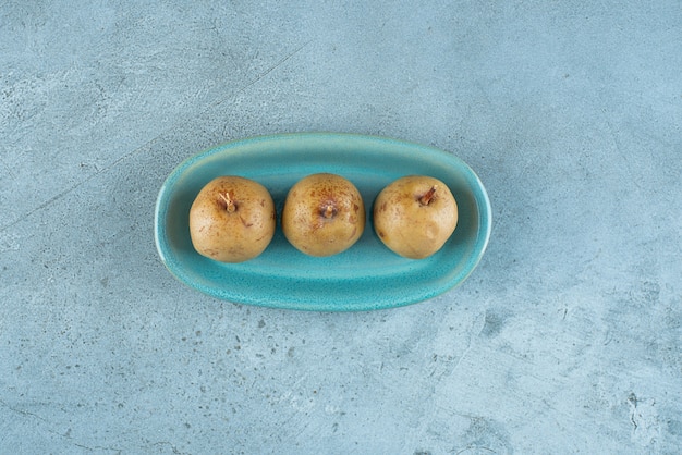 Fermented apple on a plate on the marble surface