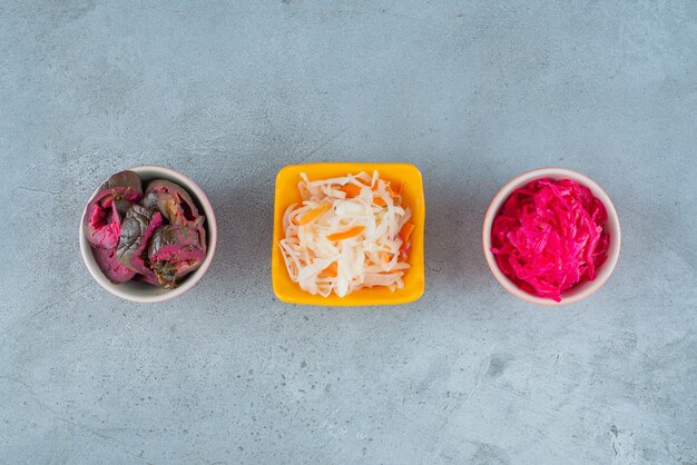 Fermented vegetables in bowl , on the marble table. 