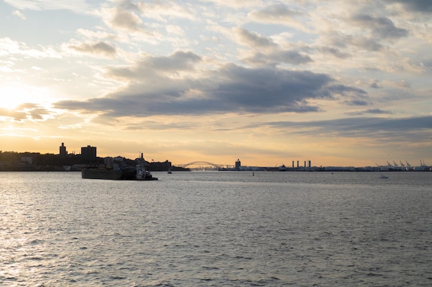 Free Photo ferry to manhattan. view of manhattan from the water at sunset, new york, usa