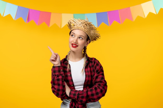 Festa junina blonde cute girl in straw hat brazilian festival with colorful flags looking up