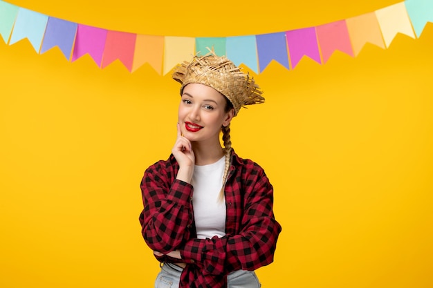 Festa junina blonde cute girl in straw hat brazilian festival with colorful flags thinking