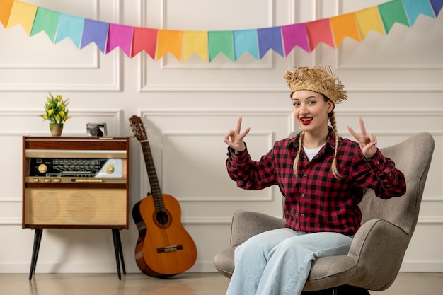 Free Photo festa junina cute girl in straw hat brazilian midsummer with retro radio guitar showing peace sign