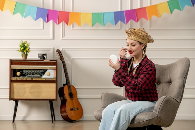 Free Photo festa junina cute girl in straw hat brazilian midsummer with retro radio putting makeup on