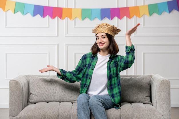 Free photo festa junina cute lovely girl in green shirt straw hat with colorful flags waving hands