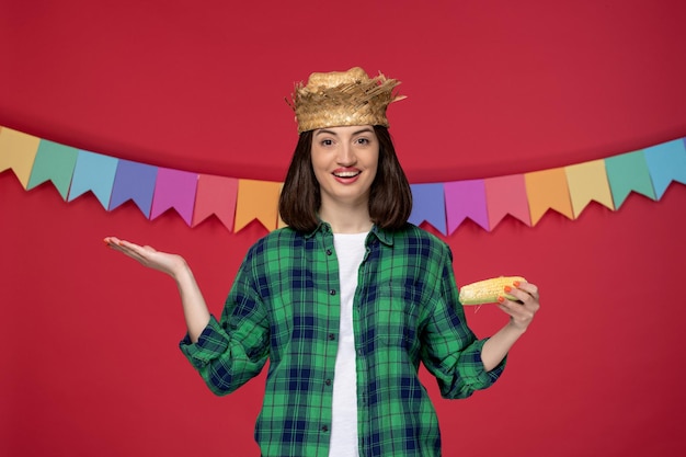 Free Photo festa junina happy cute girl wearing straw hat celebrating brazilian festival holding corn