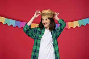 Free photo festa junina lovely cute girl wearing straw hat celebrating brazilian festival touching hat