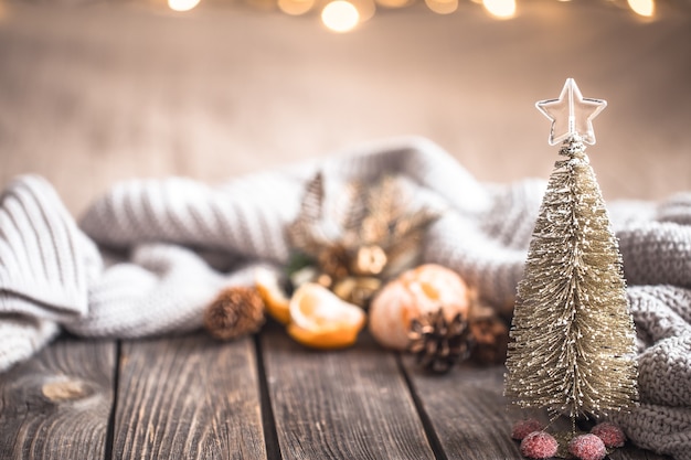 Festive Christmas cozy atmosphere with home decor and tangerines on a wooden background, home comfort concept