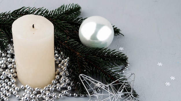 Free photo festive composition of candle and ornaments