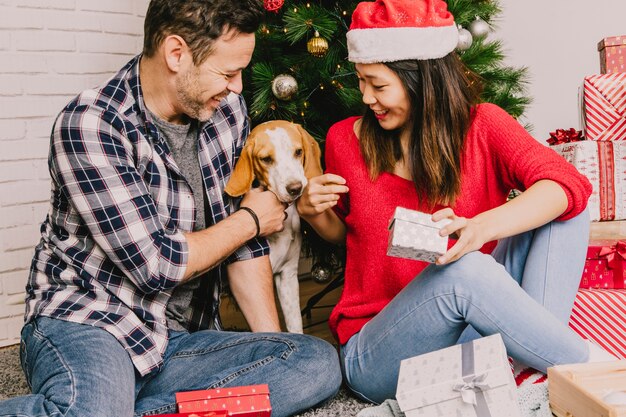 Festive couple celebrating christmas with dog