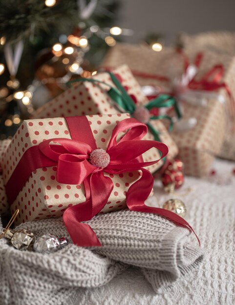 Festive gift boxes under the Christmas tree closeup