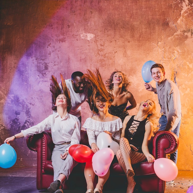 Free Photo festive men and women holding balloons