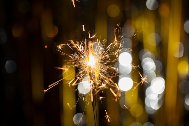 Free photo festive shiny sparkler in the dark