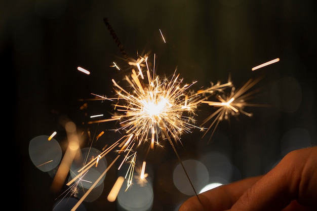 Free photo festive shiny sparkler in the dark