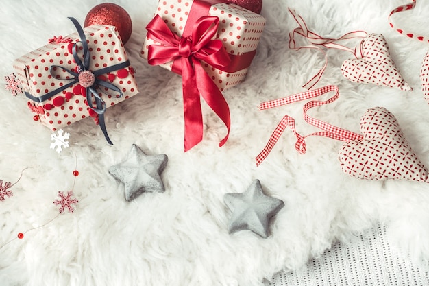 Festive wall with a Christmas gift and Christmas decor items .