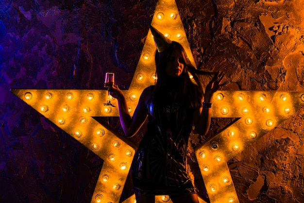 Festive woman illuminated with star