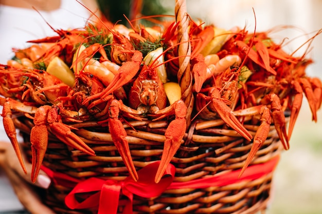 Free Photo festive woven gift basket for a man with crayfish and lemons