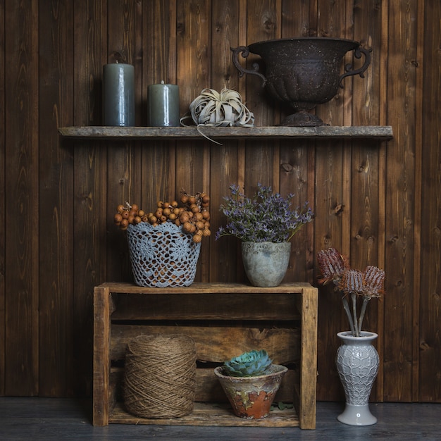 Free Photo fidderent baskets and vases of flowers standing on rustic stands 