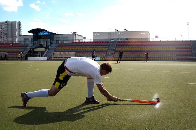 Field hockey player in equipment on the grass