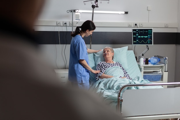 Free photo fiendly doctor hands holding patient hand, in hospital room giving encouragement, empathy, support during medical examination