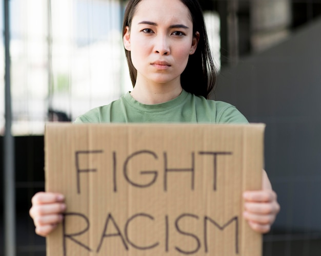 Free photo fight racism quote on cardboard front view