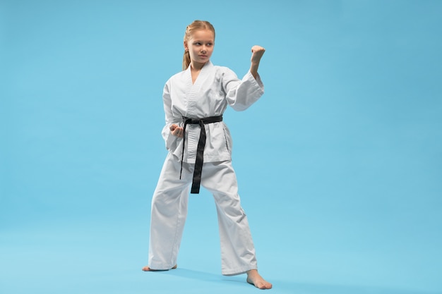 Fighter in kimono looking aside and fighting in studio