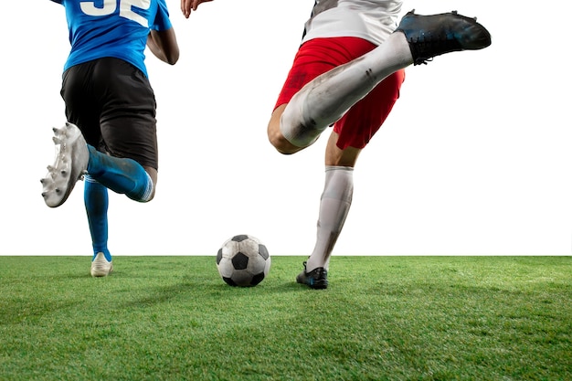 Free photo fighting. close up legs of professional soccer, football players fighting for ball on field isolated on white wall. concept of action, motion, high tensioned emotion during game. cropped image.