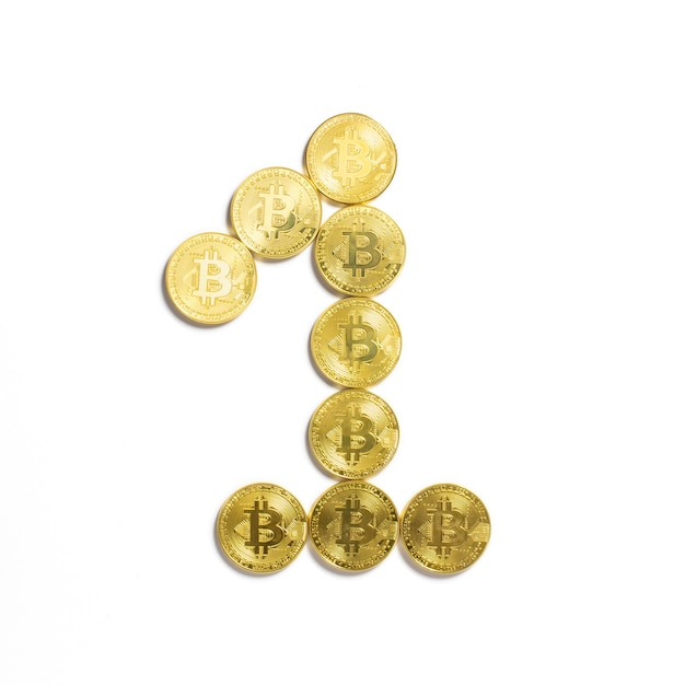 Free Photo the figure of 1 laid out of bitcoin coins and isolated on white background