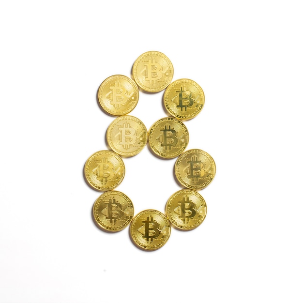 The figure of 8 laid out of bitcoin coins and isolated on white background