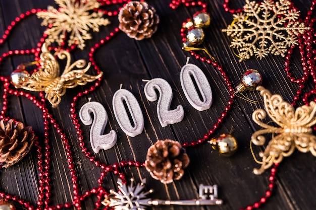 Free photo figure of new year from red necklace. spruce branches on wooden boards, top view. christmas decorations on wooden background. copy space