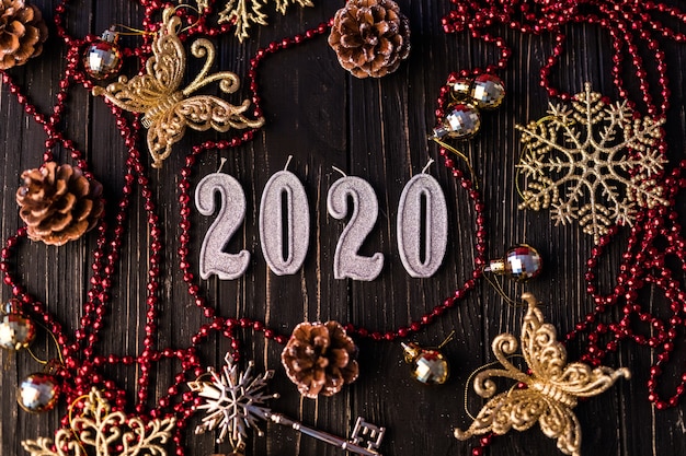 Free Photo figure of new year from red necklace. spruce branches on wooden boards, top view. christmas decorations on wooden background. copy space