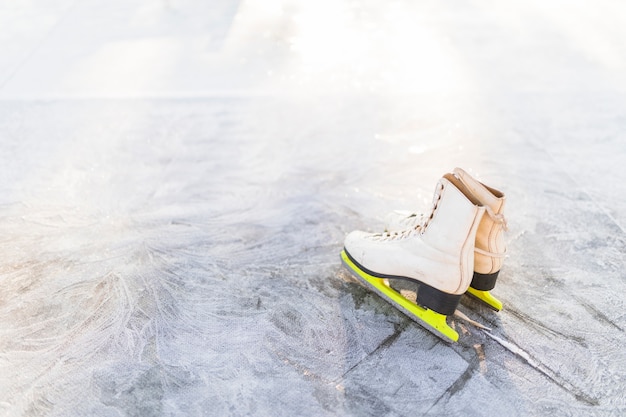 Free photo figure skates on cracked ice