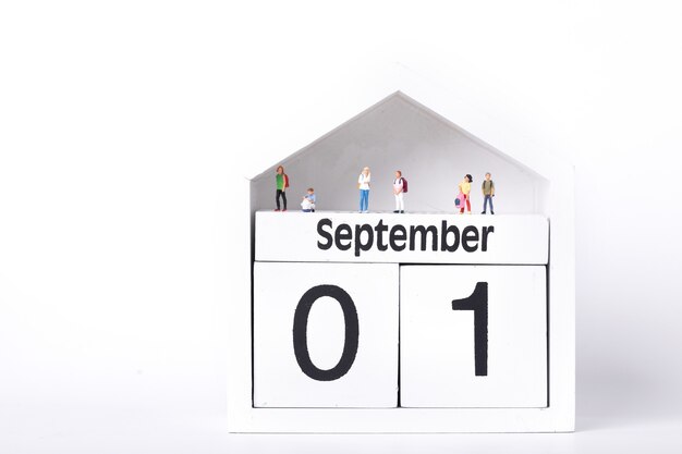 Figurines of students standing on a calendar depicting the first of September